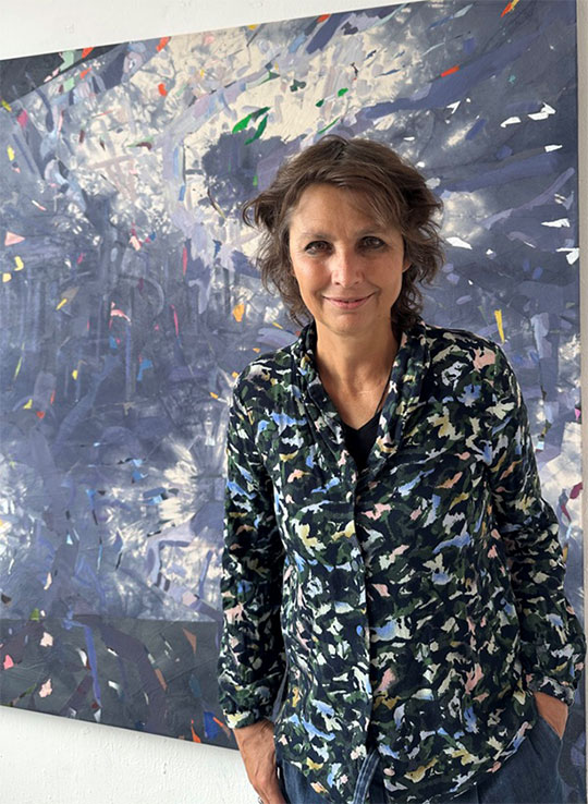 woman standing in front of a painting