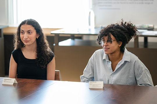 two young women sitting at a table