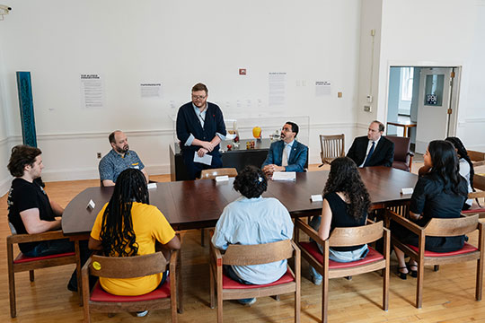 several people around a large table talking