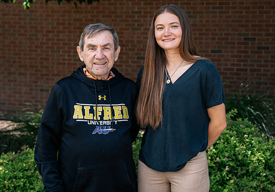 older man standing next to a woman