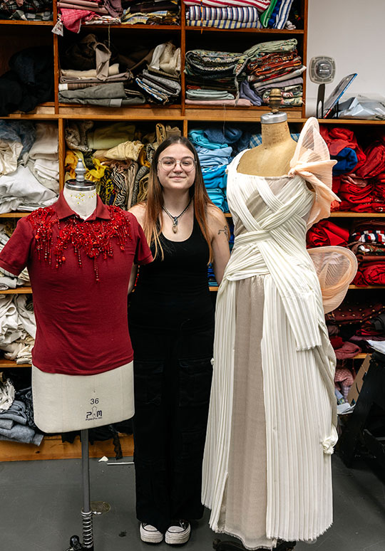 woman standing by some costumes