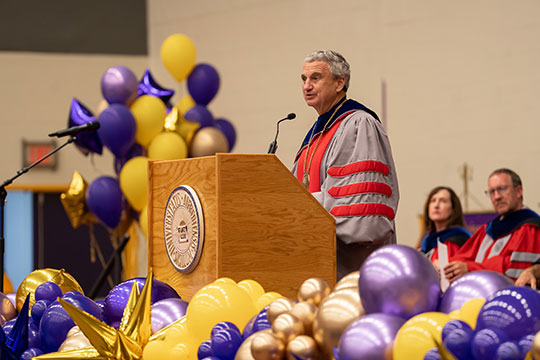 man speaking at podium