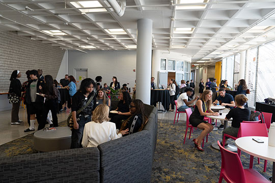 scores of people in an open area talking