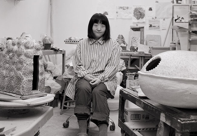 woman standing with some sculture artwork