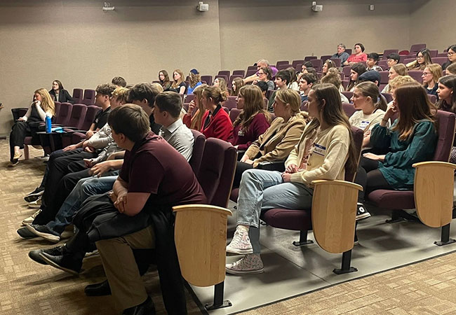 group of youngsters sitting in an auditorium