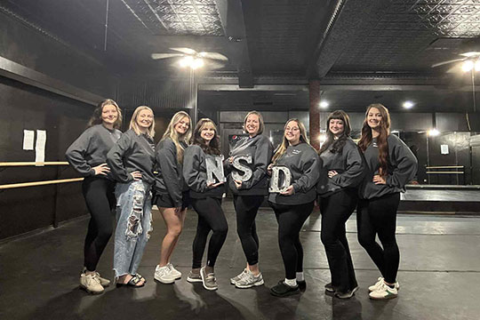 group of people standing in a row