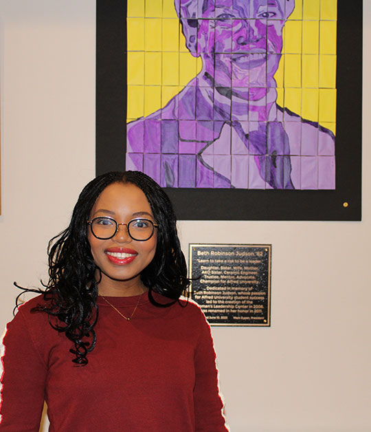 woman standing in front of a mosaic