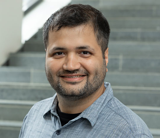 headshot of a man wearing glasses