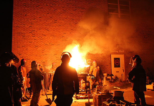 people gathered around forging sites and flames