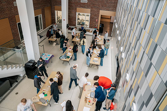 several people moving around tables