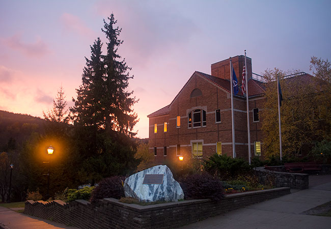 big brick building itch sun setting behind it