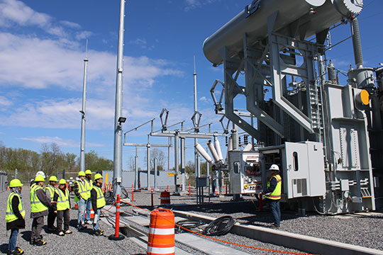 people standing in frnt of an electrical transformer