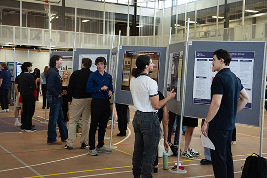 several people gathered in front of posters