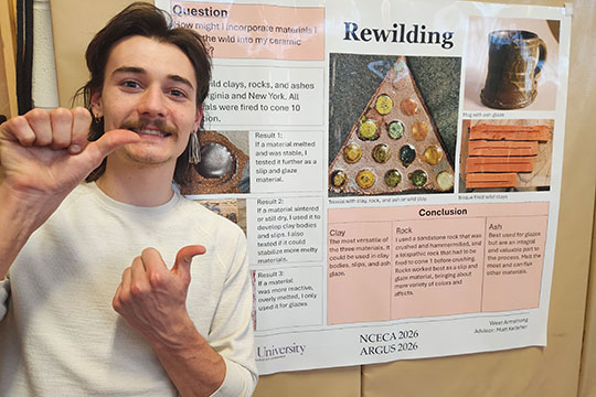 man standing in front of a poster