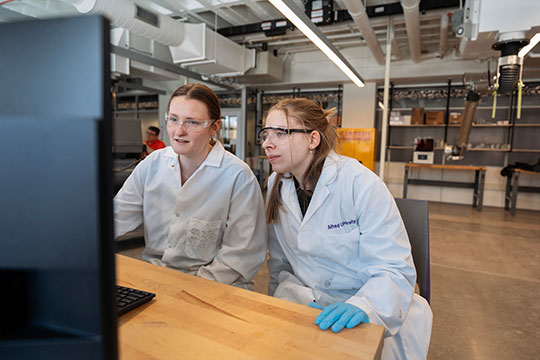 two women looking at a computer