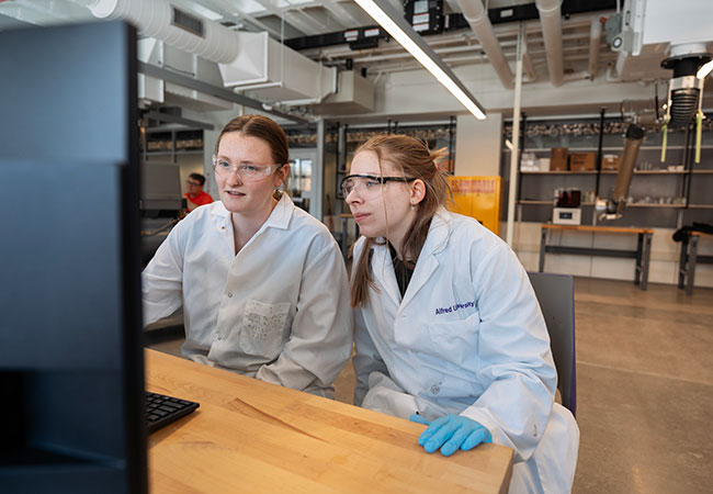two women looking at a computer screen