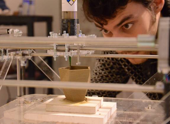Male student watching 3D printing