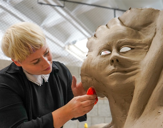 student working with ceramics