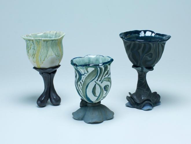 Three hand-built chalices made of individual parts with fluid designs. 