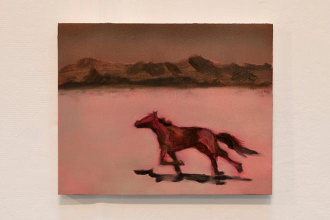 A pink mountain landscape with a galloping black horse. 