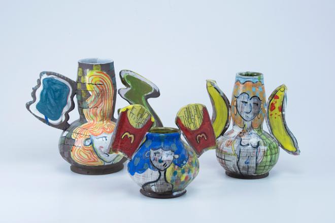 Three vases arranged in on one photo. The vase have shapes added to both sides; the vases are decorated with the faces of women and junk foods. 