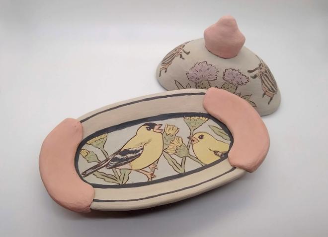 Ceramic lidded butter dish with birds and flowers painted.