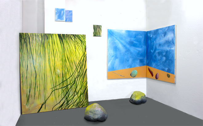installation in studio of landscape and rocks and nature like grass and clouds