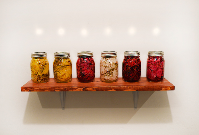 canning jars filled with roses, baby's breath, sugar, and vinegar