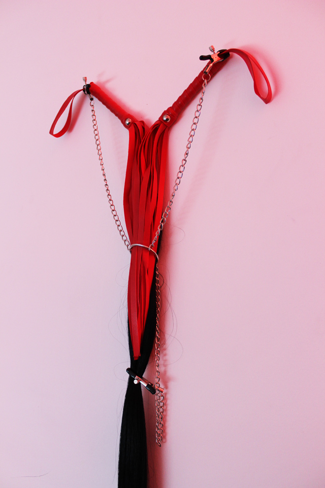 leather floggers, hair, metal chain, and nipple clamps