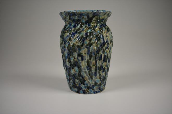 Hand carved ceramic vase with surface texture to mimic abstract waves
