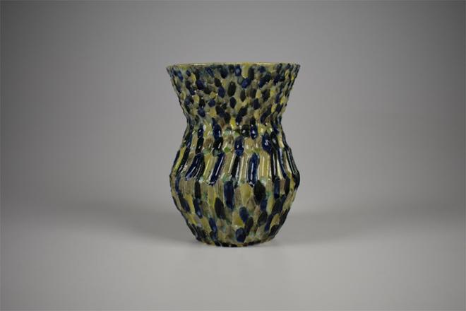 Hand carved ceramic vase with highly concentrated surface decoration