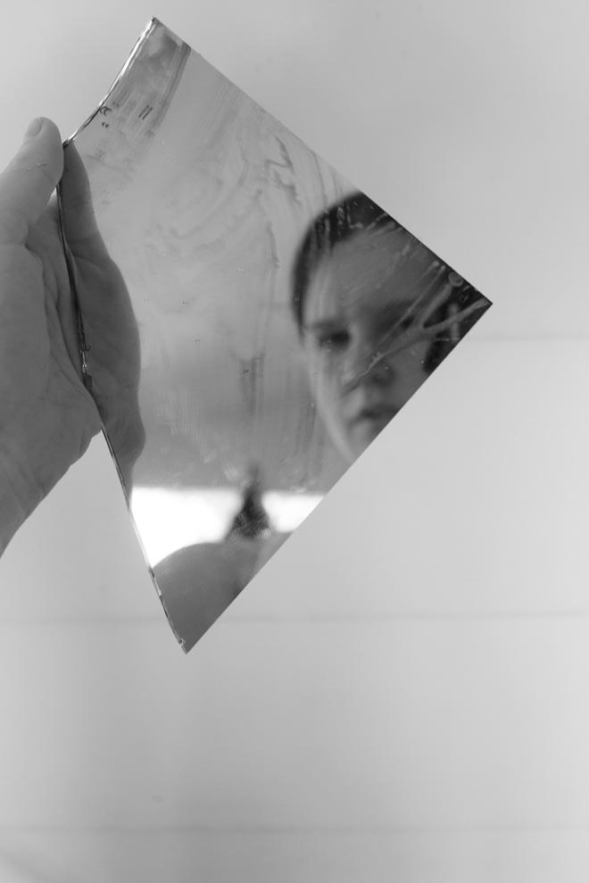 A self Portrait of a person through a broken mirror. 