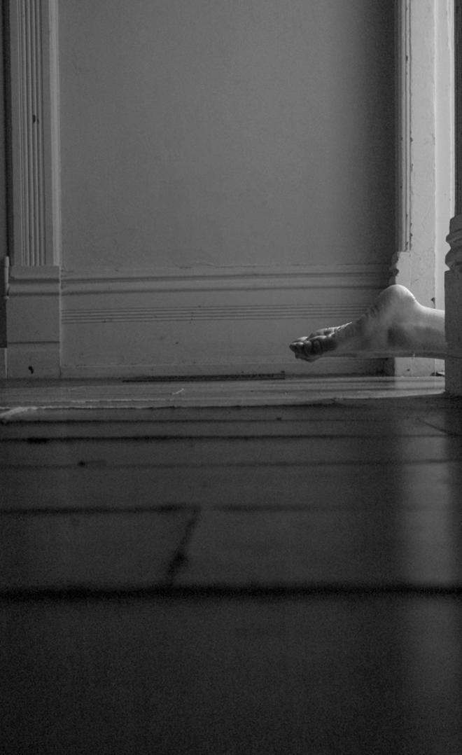 Wooden floors with feet floating inches above them in a door frame. The pictures get cut off so you're lost in suspense about the moment unraveling in front of you.