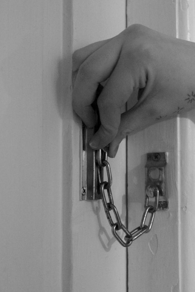 a hand unlocking a forbidden door
