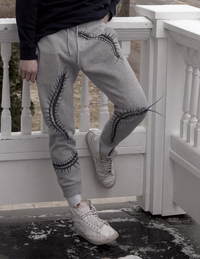 Gray sweatpants with several large centipedes on them. 