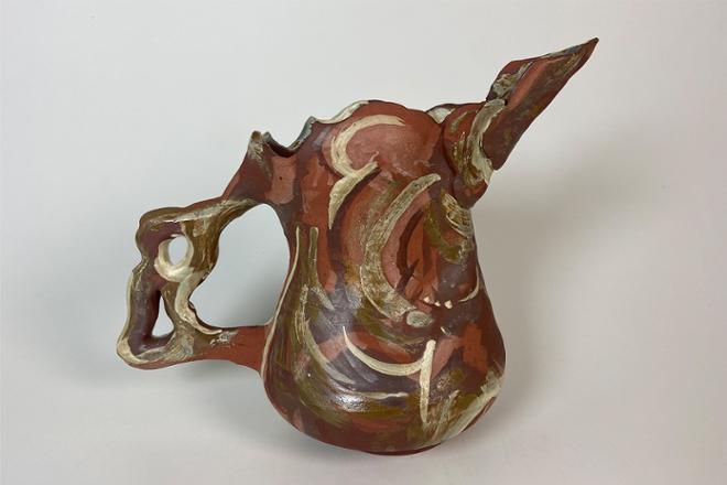 Neutral colored, ceramic pitcher with bird-like spout, wavy rim, and large curvy handle. This form was generated from line drawings of my sister (Paige) and has an abstracted painterly quality to the glaze application.