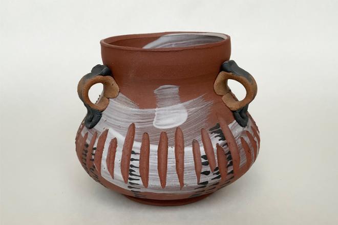 Four different neutral colored clay bodies are unified to create a vessel complete with three lub handles and slip for additional surface design. 