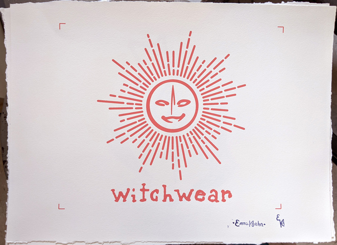 Print of a peach-colored fictional company logo depicting a stylized sun with a smiling face, and the word ‘witchwear’ below