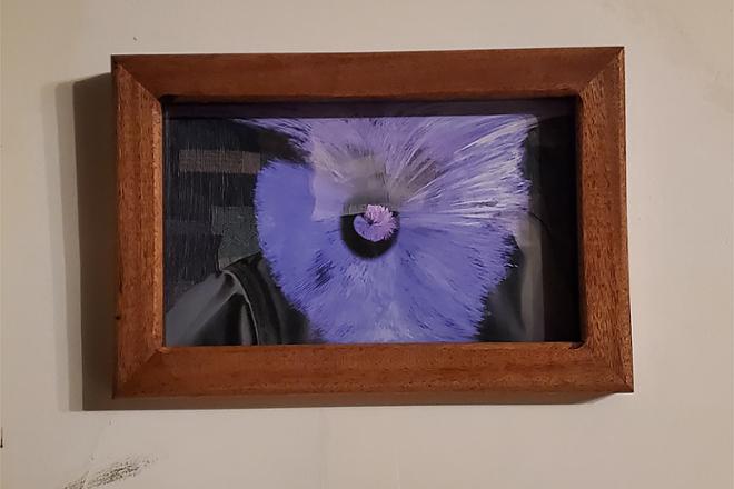 Framed watercolor print of abstract purple spherical shapes behind museum glass. 