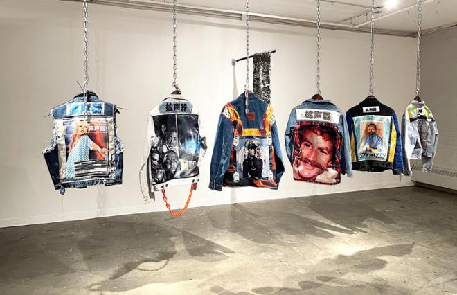 Six of the gang jacket collection hung in a row from ceiling with chain. 