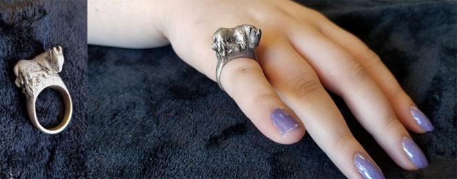 A deer ring worn by a model