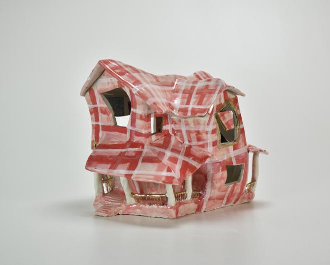 Distorted ceramic house, covered in a pink flannel fabric pattern, with gold and opal luster accents.