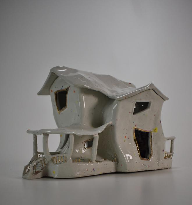 Distorted ceramic house,with multi colored confetti grog and gold luster accents.