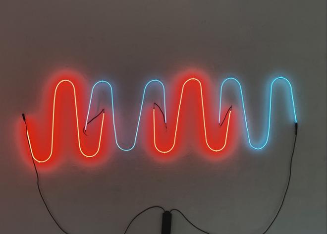 A neon sculpture using red and blue light to depict changes over time 
