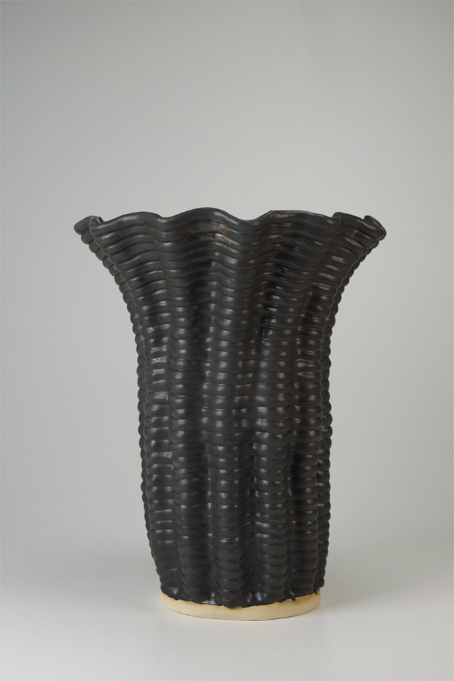 Black glazed, with a flared opening, vessel. 