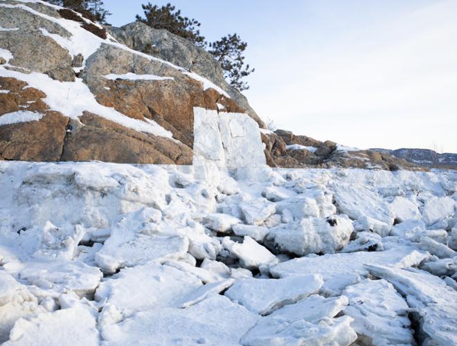Photography of a rocky landscape with a frozen line created from the tide. A portal, a rectangular shaped was painted on the rocks