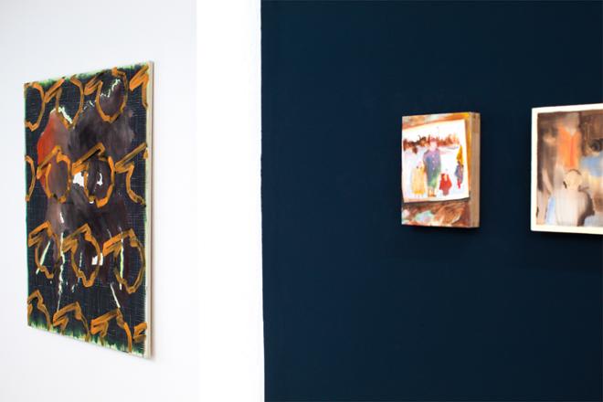 An installation shot from an angel looking at both Isabel Monti’s miniature paintings on dark blue wall (to the right) and Orange and Railway on white wall (to the left).  