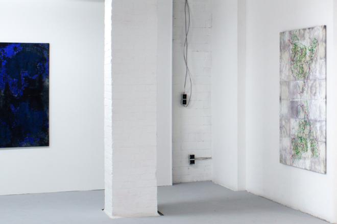 An installation shot with partial view of The Blues (to the left) and Recalling (to the right). In the middle is a white brick pillar.  