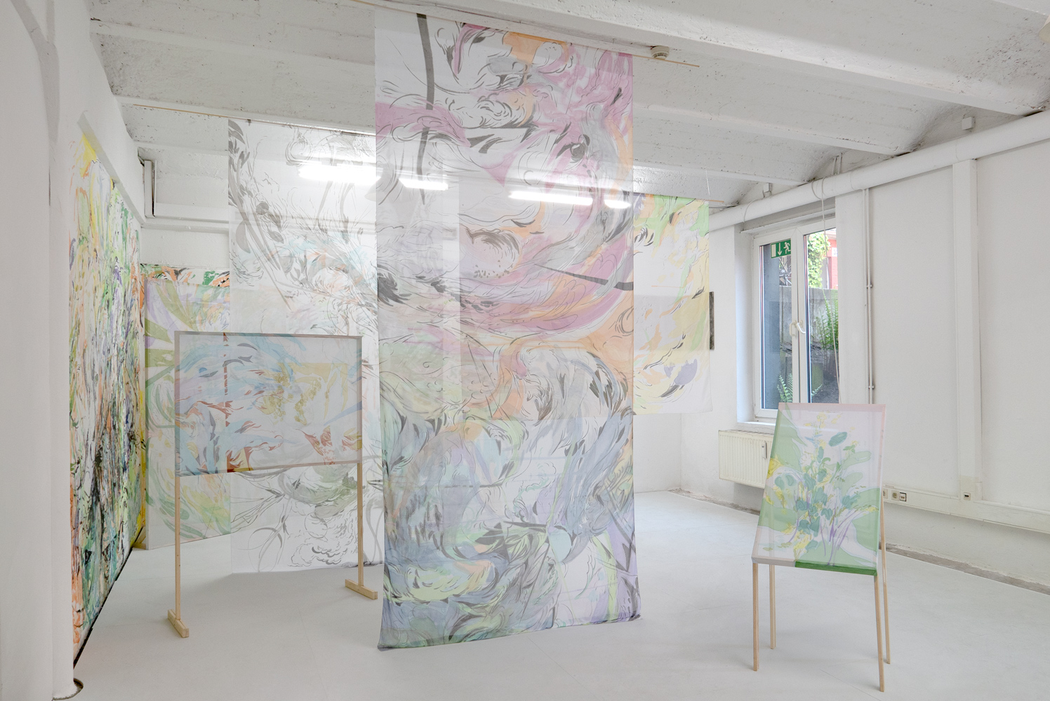 Installation work of colorful improvised drawings on six chiffon fabrics and a wall 