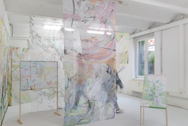 An installation shot, reflecting the movement of a person behind a transparent chiffon 